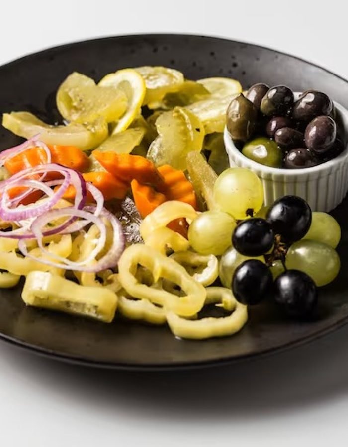 imgi_34_plate-with-marinated-pickles-pepper-onions-carrots-with-white-black-grapes-olives_181624-26627